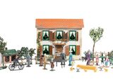 toy figurines of people standing in front of a building with a horse drawn carriage