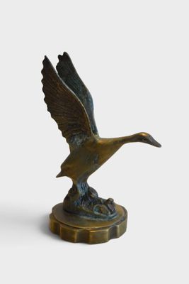 an image of a bronze statue of a duck on a pedestal