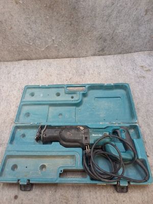 a drill in a blue case on the floor