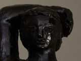 statue of a woman holding a piece of wood in her hands