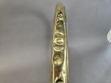 a close up of a gold plated spoon on a table