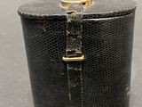 an image of a black box with a gold handle on a table