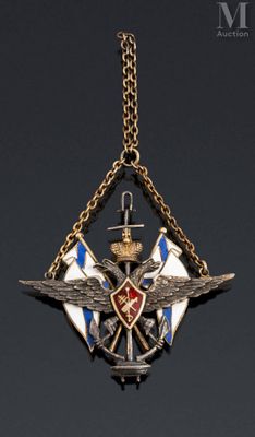 an image of a necklace with a cross and wings on it