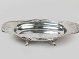a silver plate with a design on the bottom