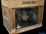 a toy of a dinosaur in a box on a black background
