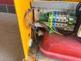 a yellow box with a bunch of wires on top of it
