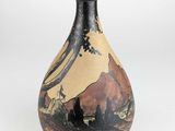 a vase with a painting on it sitting on a table