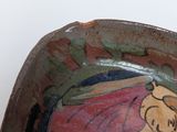 a small bowl with a picture of a woman on it