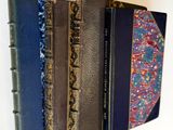several books are lined up on a shelf in a row