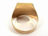 an image of a close up of a gold ring on a white surface