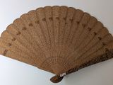 a fan that is hanging on the wall next to a wall