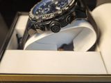 a close up of a watch in a box on a table
