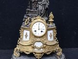 a clock with a statue on top of it