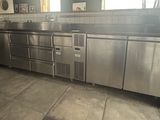 a large stainless steel kitchen with a lot of counter space