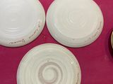 a pink table with plates and bowls on it