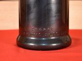 a silver bell on a red table cloth with a wooden block in the background
