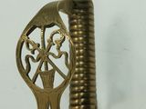 a gold sword with a bird on top of it