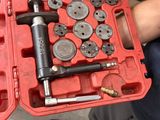 a man that is holding a tool in a red case