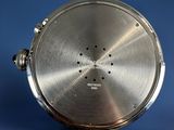 a close up of a silver pocket watch on a blue surface