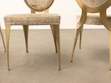 three chairs in a room with a wall in the background