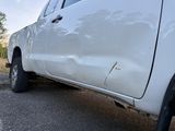 a white truck that is parked on the side of the road