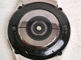 a close up of a watch on a white surface