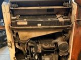 a small television sitting on top of a machine in a garage