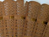 several brown paper fans are lined up on a white surface