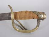 an old sword with a gold handle on a white background
