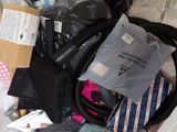 a bag full of items that are sitting on a bed