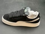 puma sued sued trainers in black with white soles and a clear plastic bag