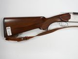a shotgun with a wooden handle on a white background