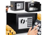 a person holding a remote control in front of a safe box