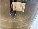 a person holding a ticket in front of a machine