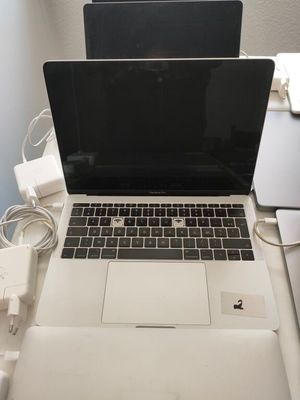 a laptop computer sitting on top of a white desk