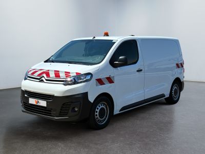 the white van is parked in a white room with a red and white stripe on the side