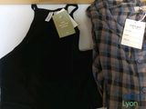 two shirts that are hanging on a wall