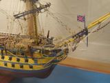 a model of a ship on display in a glass case
