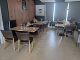 many tables and chairs in this restaurant setting