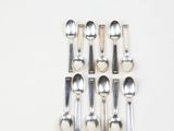six spoons and two spoon spoons on the table
