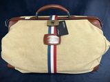 an old suitcase with a tag on it sitting on a blue background