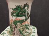 a vase with a dragon on it sitting on a table