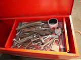 a red tool box filled with wrenches and other tools