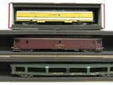 three train cars that are in a box on a table