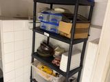 a small room with shelves and bins in it