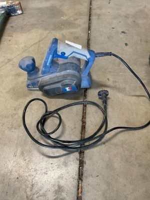 an image of a corded sander on the ground