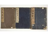 three books with chinese writing on them sitting on a white surface