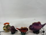 a group of three glass figurines of different shapes and sizes