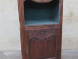 an old wooden cabinet with a glass door on top of it