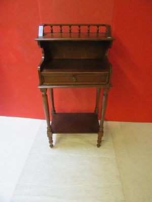 a small wooden desk with a drawer on it